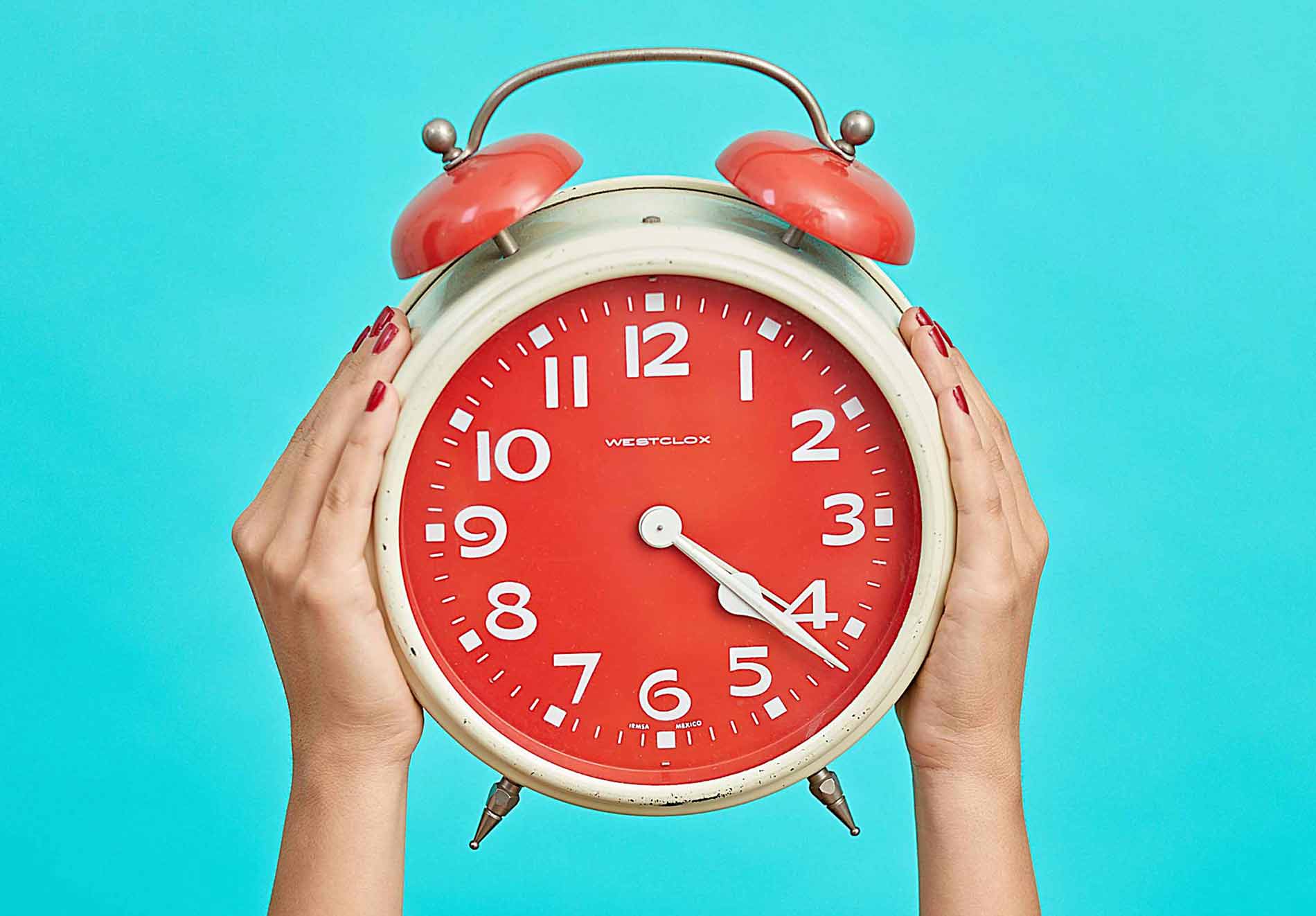 Two Hands Holding Big Alarm Clock